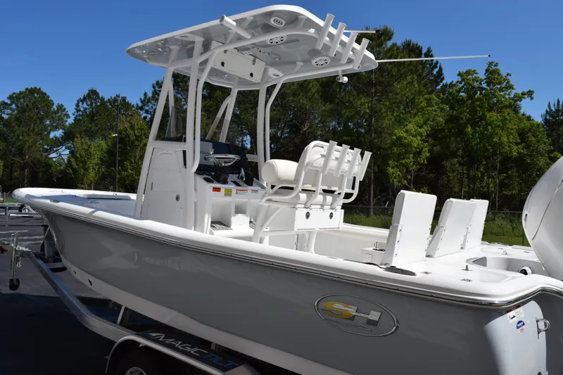 Slide: The Image of 2026 Sea Hunt BX 22 BR boat with T-top and seating, parked on trailer. - 6