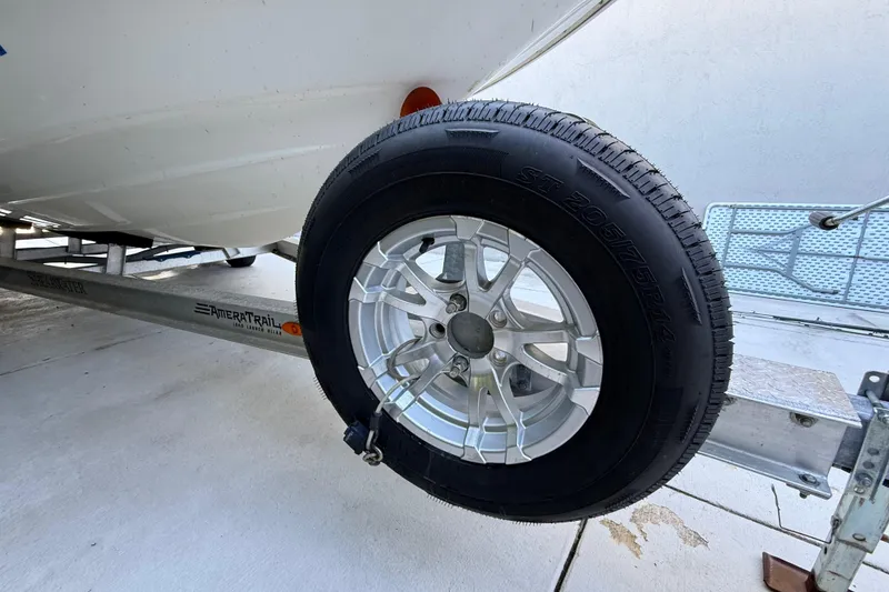 Slide: The Image of Trailer wheel of a 2023 ShearWater x22 boat on AmeraTrail trailer. - 13