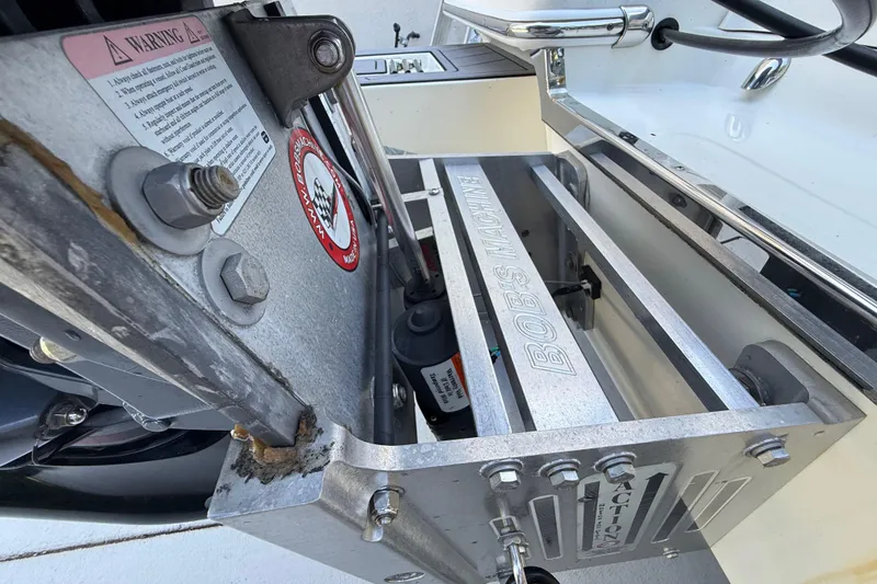 Slide: The Image of ShearWater x22 2023 boat engine mount with Bob's Machine components and warning label. - 16