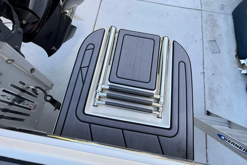 Slide: The Image of 2023 ShearWater x22 boat swim platform with foldable ladder and sleek design. - 20