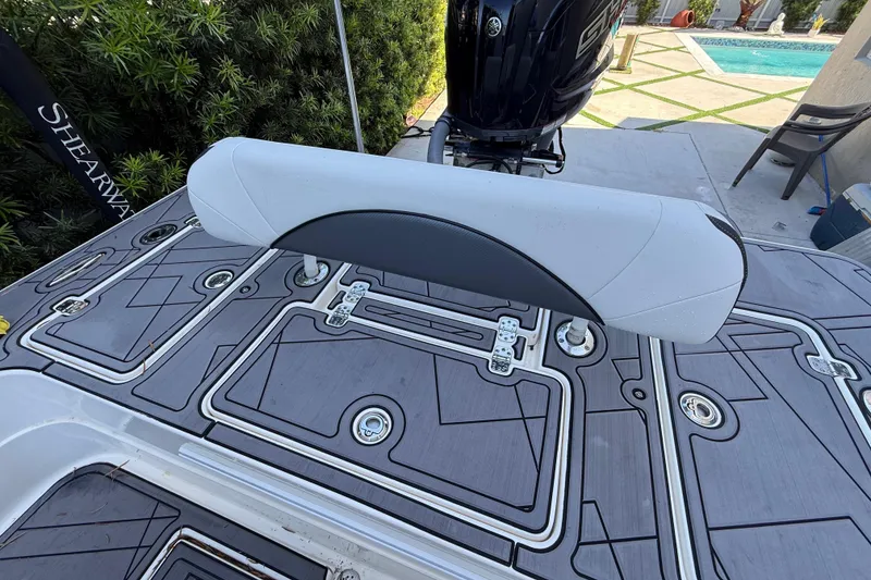 Slide: The Image of 2023 ShearWater x22 boat deck with cushioned seat and sleek design. - 23