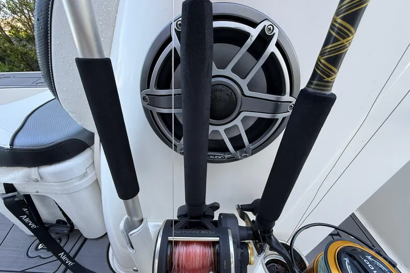 Slide: The Image of Fishing rods and speaker on a 2023 ShearWater x22 boat deck. - 25