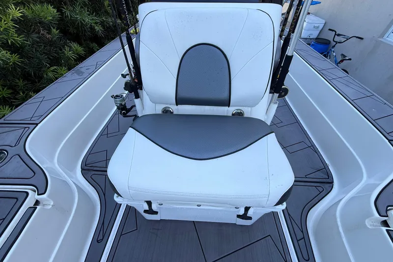 Slide: The Image of ShearWater x22 2023 boat seat with gray and white upholstery, surrounded by sleek deck design. - 26