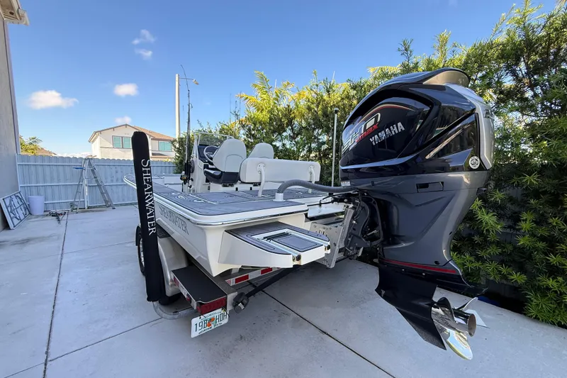 Slide: The Image of 2023 ShearWater x22 boat with Yamaha engine, parked outdoors on a sunny day. - 3