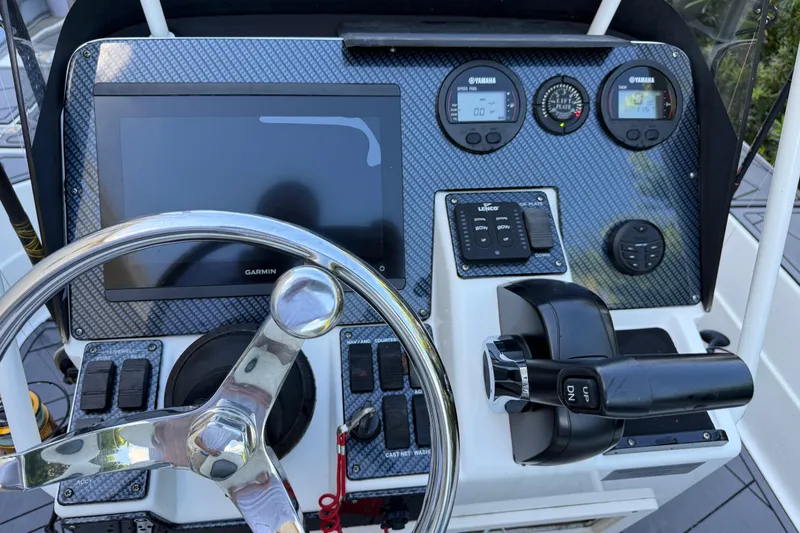 Slide: The Image of Control panel of 2023 ShearWater x22 boat with steering wheel and navigation instruments. - 30