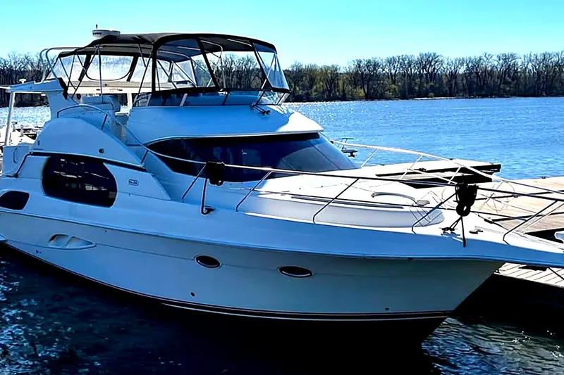 The Image of 2004 Silverton 43 Motor Yacht docked on a sunny day by the water. - 1
