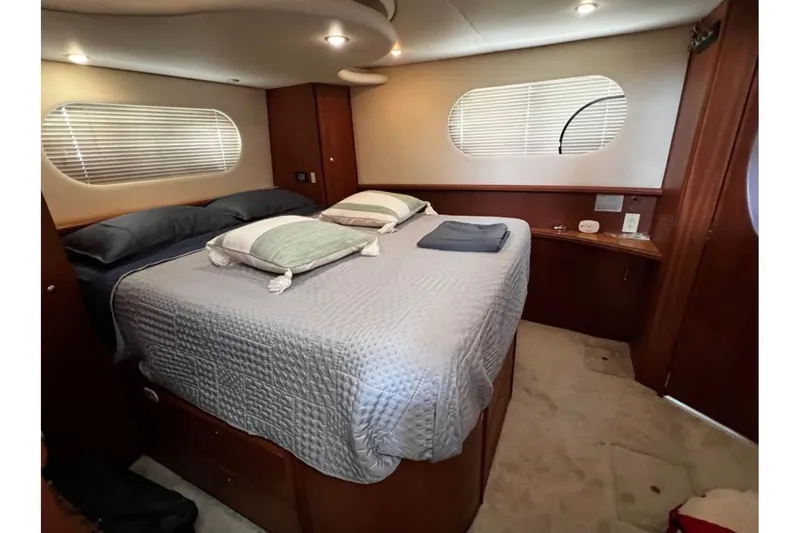 Slide: The Image of Luxurious bedroom interior of 2004 Silverton 43 Motor Yacht with cozy bedding. - 11