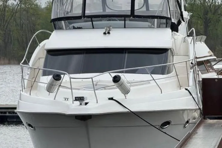 Slide: The Image of 2004 Silverton 43 Motor Yacht docked on a calm lake. - 3