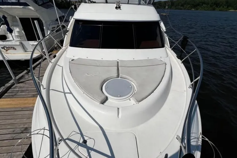 Slide: The Image of 2004 Silverton 43 Motor Yacht docked, showcasing sleek design and spacious deck. - 4