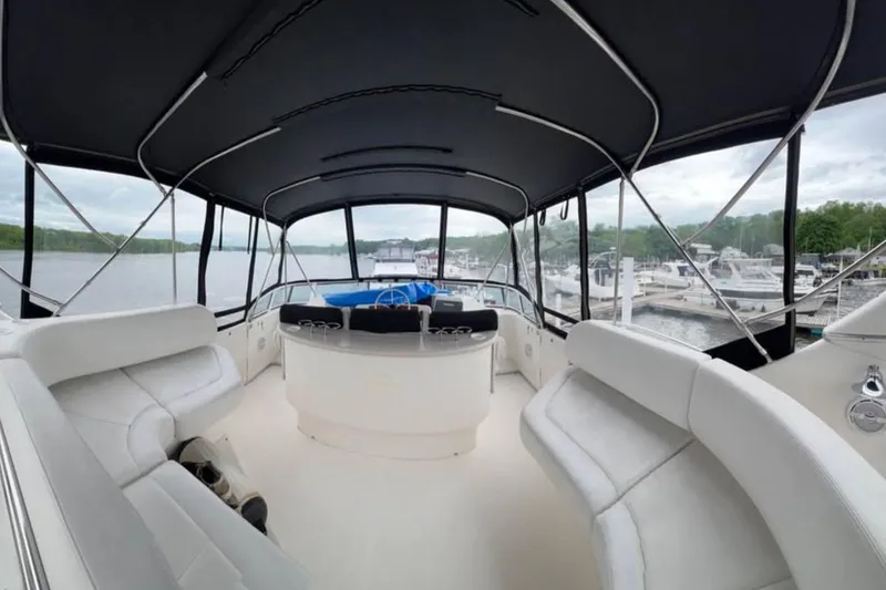 Slide: The Image of Interior view of 2004 Silverton 43 Motor Yacht with spacious seating and panoramic windows. - 6