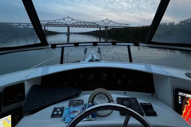 Slide: The Image of Cockpit view from a 2004 Silverton 43 Motor Yacht, approaching a bridge at dusk. - 8