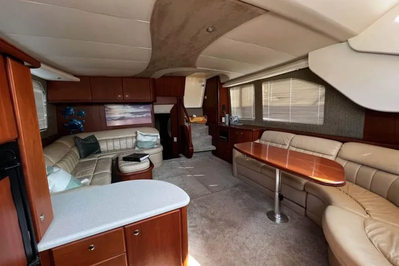 Slide: The Image of Luxurious interior of 2004 Silverton 43 Motor Yacht with elegant seating and dining area. - 9