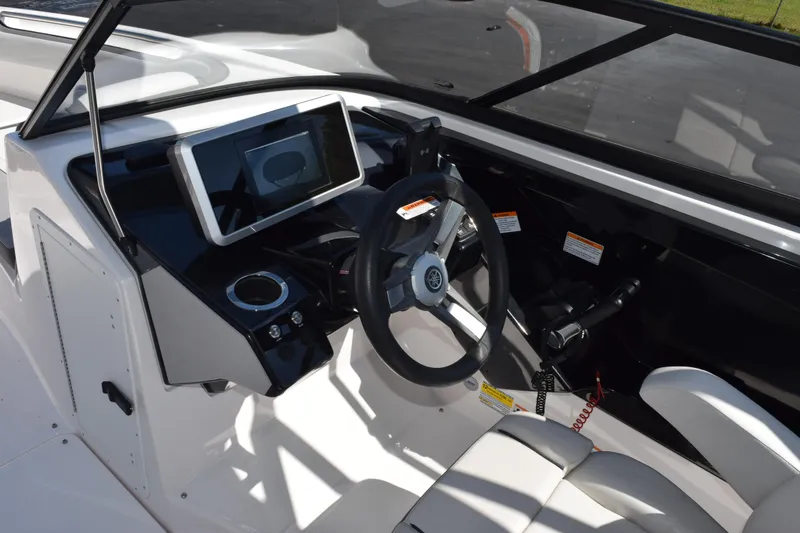 Slide: The Image of 2024 Yamaha Boats AR250 cockpit with steering wheel and digital display. - 11