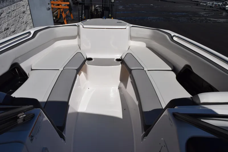 Slide: The Image of 2024 Yamaha Boats AR250 interior with spacious seating and cup holders. - 13