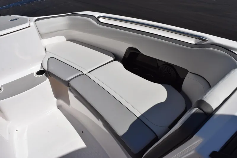 Slide: The Image of 2024 Yamaha Boats AR250 interior seating with sleek white upholstery and modern design. - 14