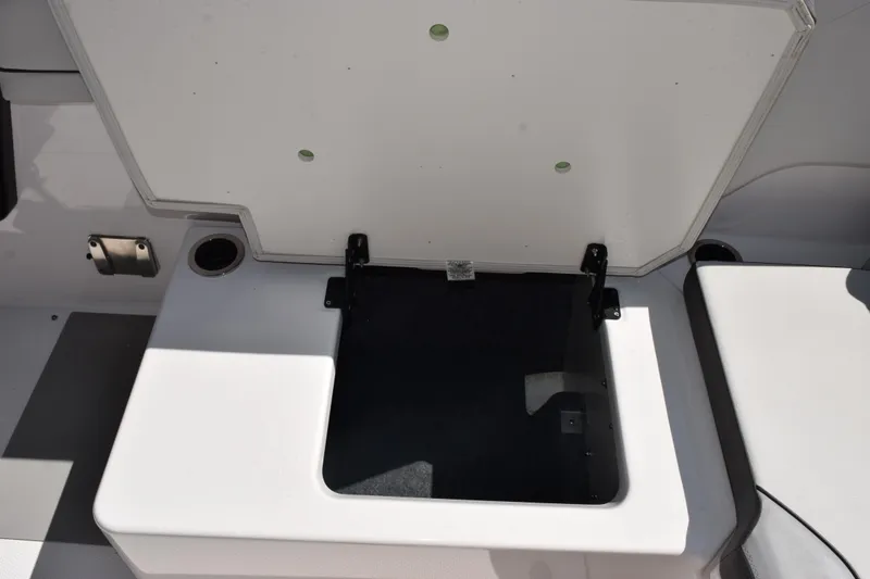 Slide: The Image of Open storage compartment on 2024 Yamaha Boats AR250, showcasing interior space. - 19