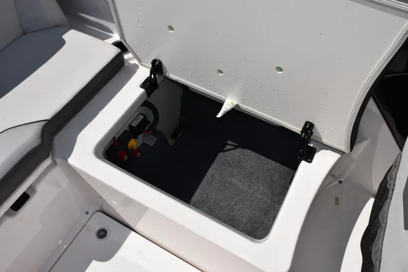 Slide: The Image of Open storage compartment on 2024 Yamaha AR250 boat, showcasing interior space and seating. - 20