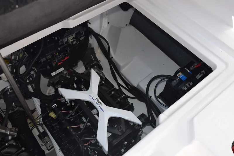 Slide: The Image of 2024 Yamaha Boats AR250 engine compartment with visible wiring and battery. - 22