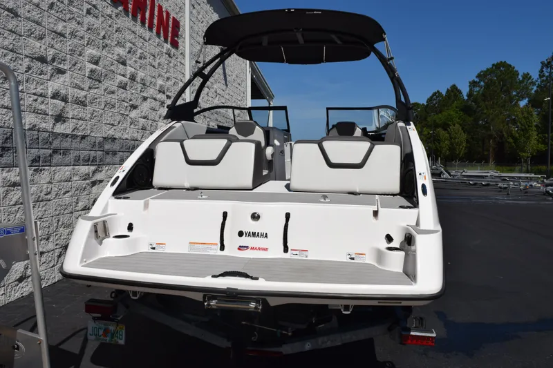 Slide: The Image of 2024 Yamaha Boats AR250, rear view, showcasing sleek design and spacious seating. - 5