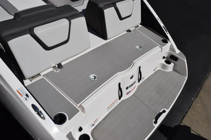 Slide: The Image of 2024 Yamaha Boats AR250 swim platform with seating and storage compartments. - 7
