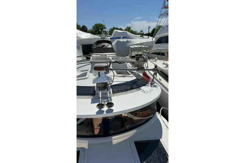 Slide: The Image of 2018 Ranger Tugs R-23 boat docked, showcasing deck and railing under clear sky. - 11