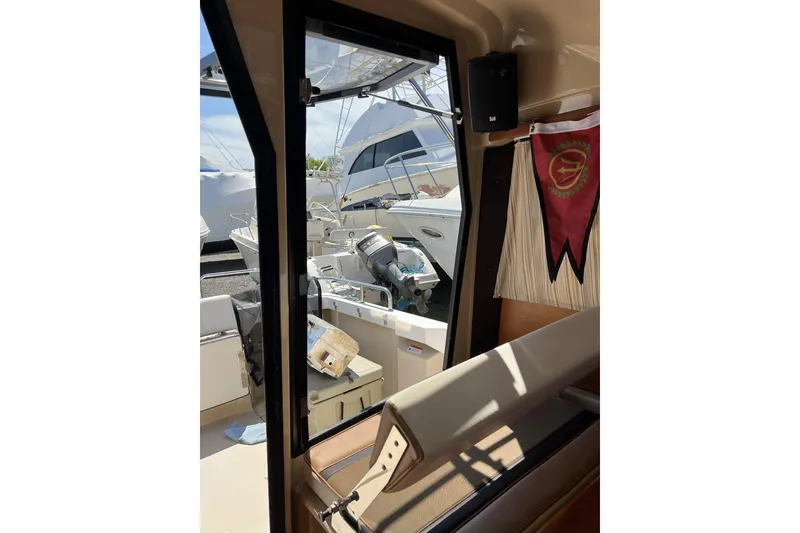 Slide: The Image of Interior view of a 2018 Ranger Tugs R-23 boat, showing the cockpit and exterior. - 15