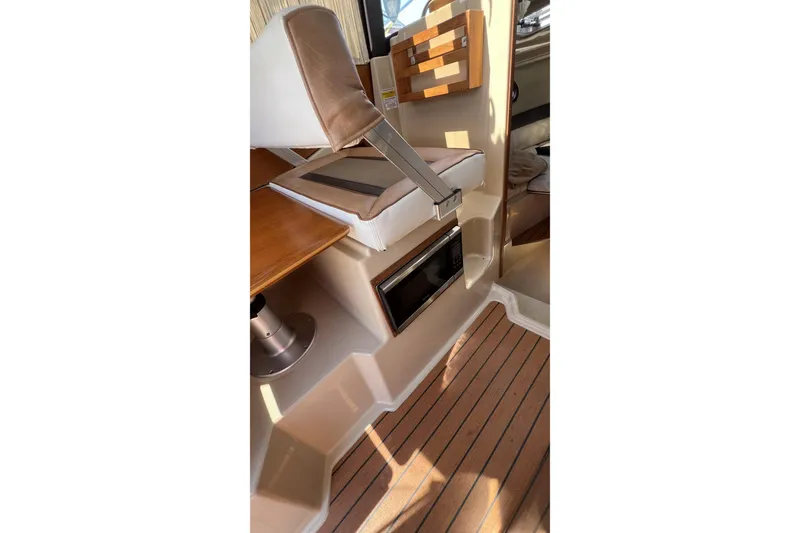 Slide: The Image of Interior of 2018 Ranger Tugs R-23 boat with seating and wooden flooring. - 17