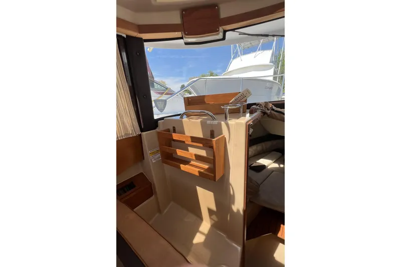 Slide: The Image of Interior view of 2018 Ranger Tugs R-23 boat, featuring wooden accents and seating area. - 19