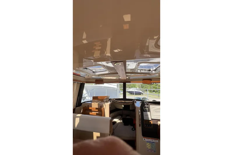 Slide: The Image of Interior view of 2018 Ranger Tugs R-23 boat with sunroof and navigation equipment. - 20