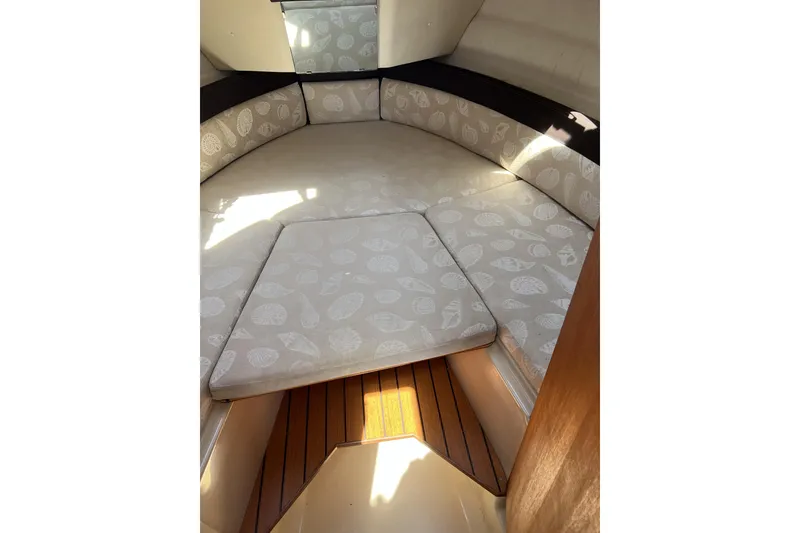 Slide: The Image of 2018 Ranger Tugs R-23 cabin interior with patterned cushions and wooden flooring. - 30
