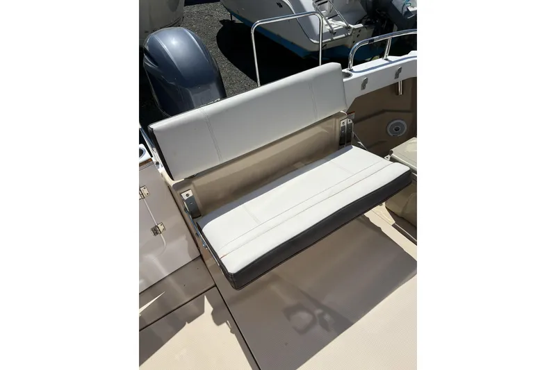 Slide: The Image of 2018 Ranger Tugs R-23 boat seat with white upholstery and sleek design. - 6