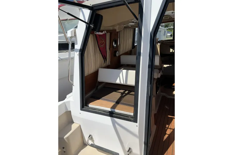 Slide: The Image of 2018 Ranger Tugs R-23 boat interior with open cabin door and seating area. - 9