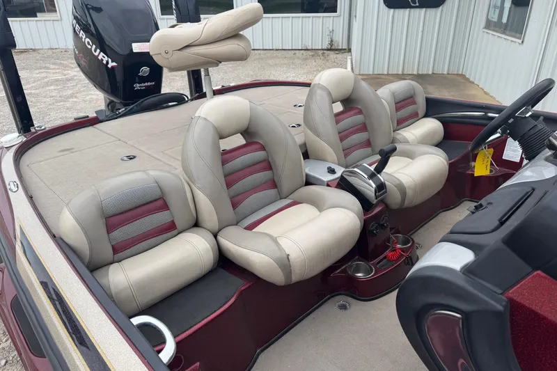 Slide: The Image of 2009 Nitro Z-9 CDC boat interior with beige and red seats, Mercury engine visible. - 10