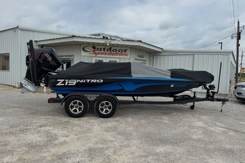 Slide: The Image of 2022 Nitro Z19 boat with cover, parked outside dealership. - 11