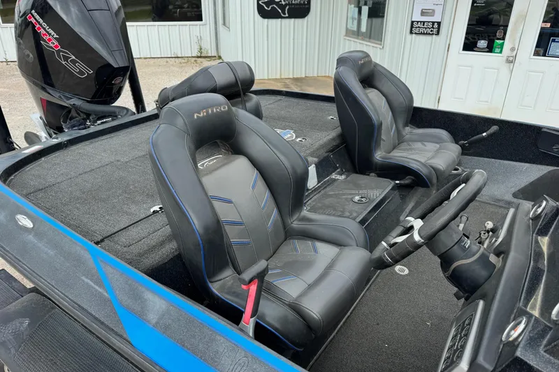 Slide: The Image of 2022 Nitro Z19 boat interior with black leather seats and steering wheel. - 7