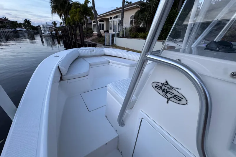 Slide: The Image of 2004 Regulator 21 Forward Seating boat docked by waterfront homes. - 11