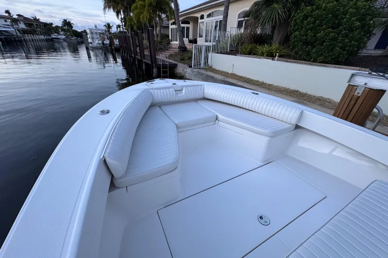 Slide: The Image of 2004 Regulator 21 Forward Seating boat docked by waterfront homes. - 13