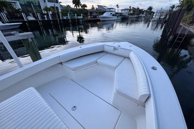 Slide: The Image of 2004 Regulator 21 Forward Seating boat docked in a serene waterfront setting. - 15