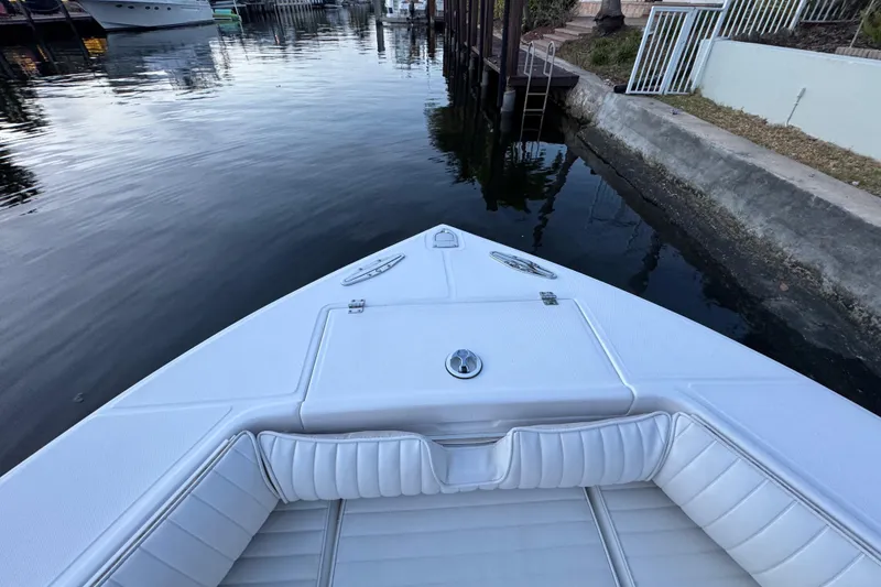 Slide: The Image of 2004 Regulator 21 Forward Seating boat docked in a calm canal. - 17