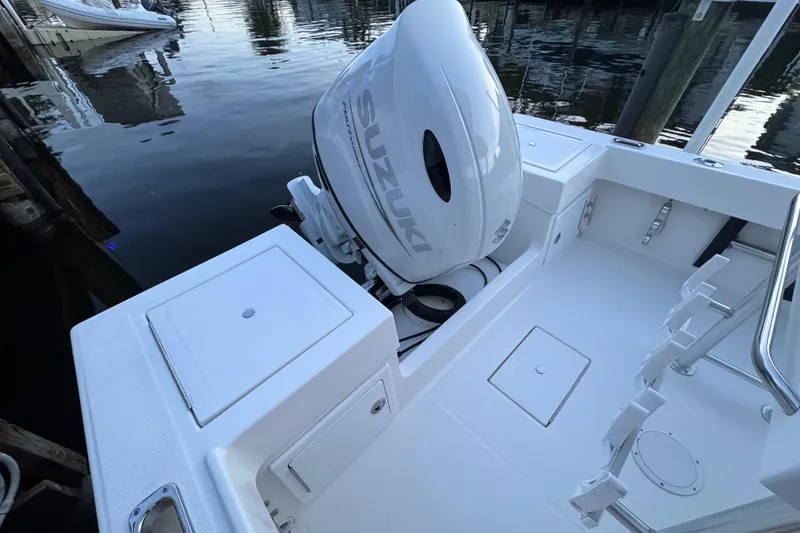 Slide: The Image of 2004 Regulator 21 Forward Seating boat with Suzuki outboard motor at dock. - 4