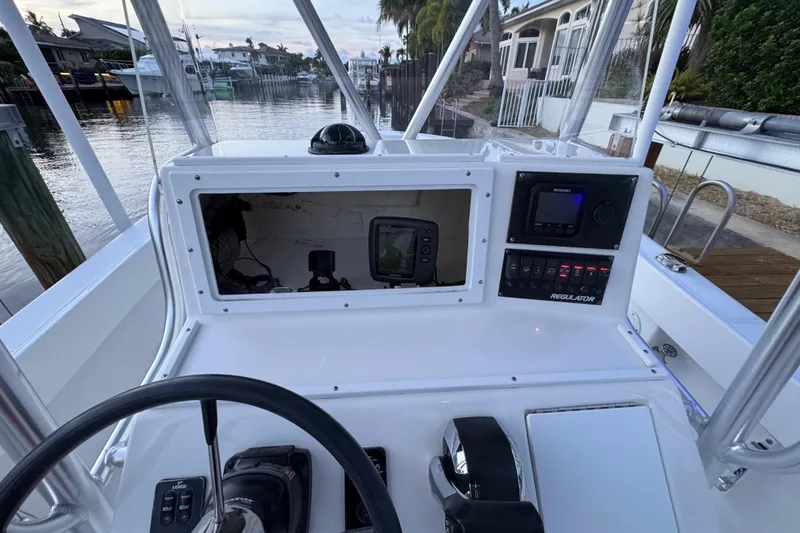 Slide: The Image of 2004 Regulator 21 Forward Seating boat dashboard with navigation controls and electronics. - 9