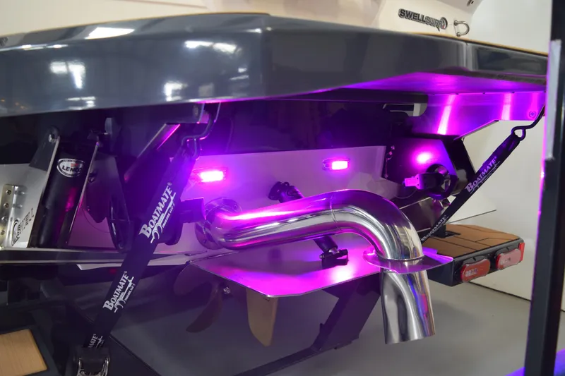 Slide: The Image of 2021 Supra SE 450 boat with illuminated purple underwater lights and polished exhaust system. - 10