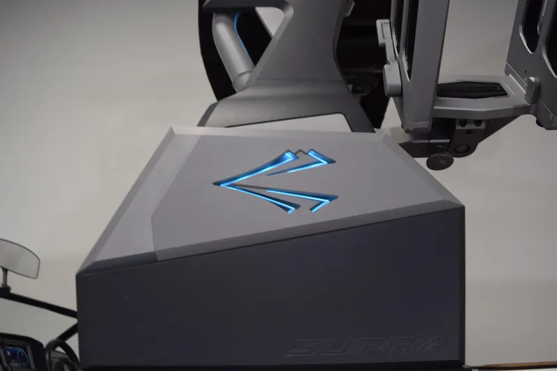 Slide: The Image of 2021 Supra SE 450 boat detail with illuminated logo and sleek design elements. - 11