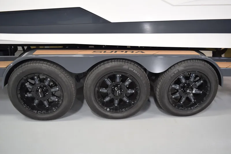Slide: The Image of Triple axle trailer with black wheels for 2021 Supra SE 450 boat. - 13