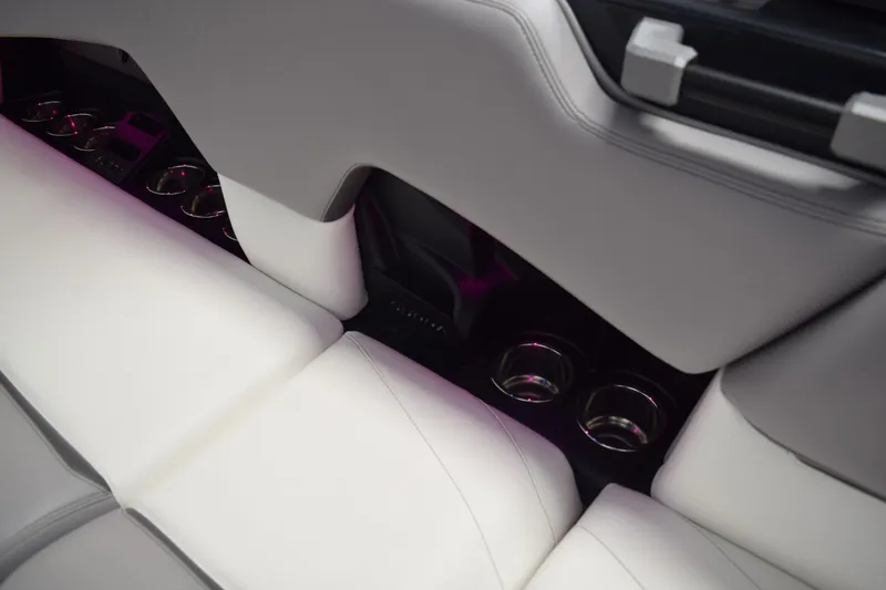 Slide: The Image of Interior of 2021 Supra SE 450 with white leather seats and cup holders. - 21