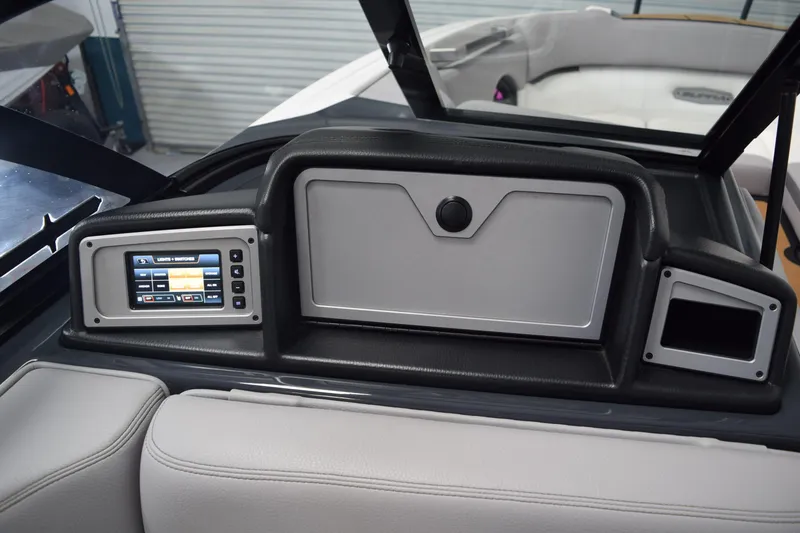 Slide: The Image of Dashboard of 2021 Supra SE 450 boat with control panel and storage compartment. - 24