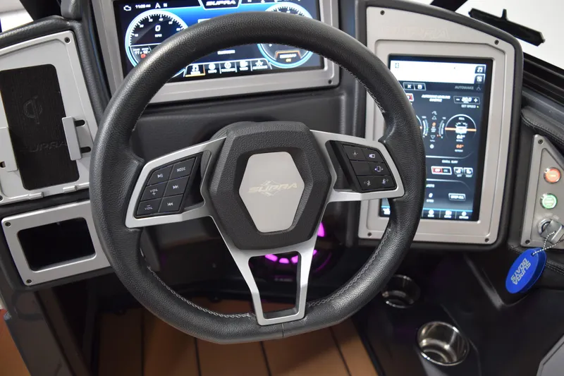 Slide: The Image of Steering wheel and dashboard of 2021 Supra SE 450 boat with digital displays. - 25