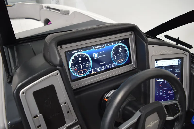Slide: The Image of Dashboard of 2021 Supra SE 450 boat with digital displays and steering wheel. - 26