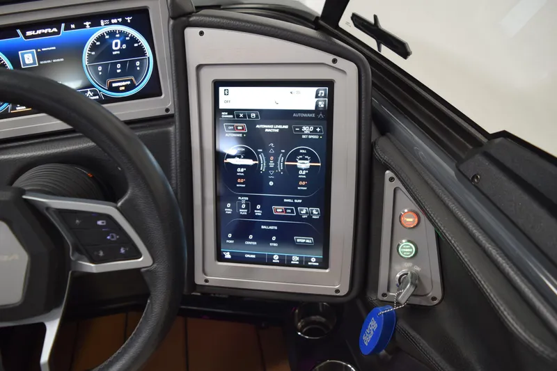 Slide: The Image of Dashboard of a 2021 Supra SE 450 with digital displays and control panel. - 27