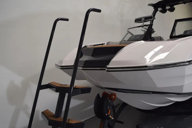 Slide: The Image of 2021 Supra SE 450 boat with boarding ladder in showroom setting. - 4